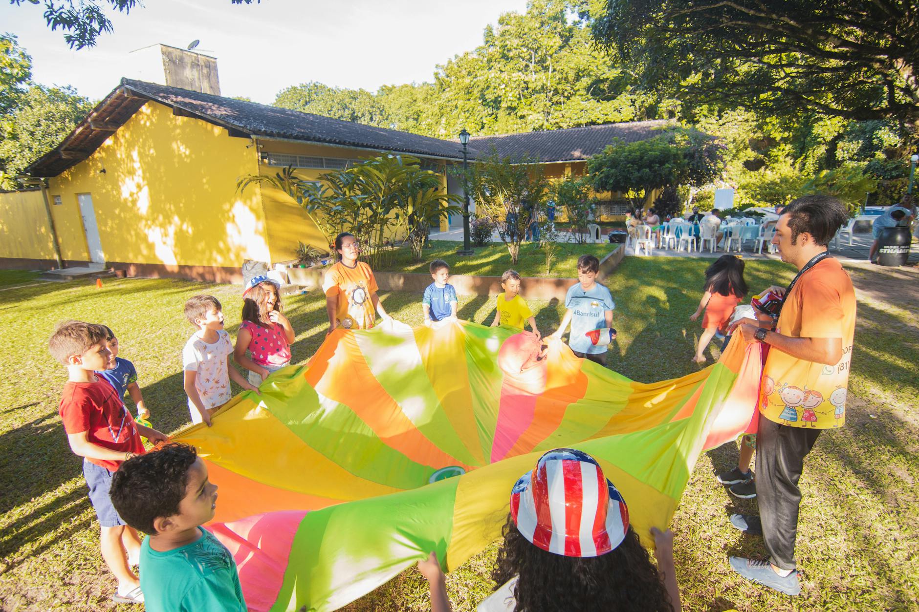 children playing with colorful kites in the yard